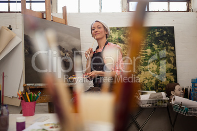 Woman painting on canvas