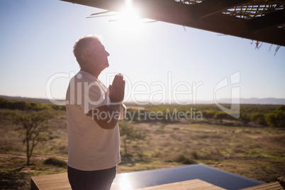 Man practising yoga on wooden plank