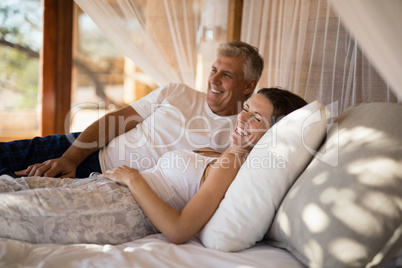 Senior couple sleeping on canopy bed