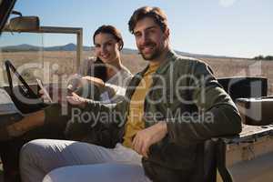 Portrait of couple sitting in off road vehicle