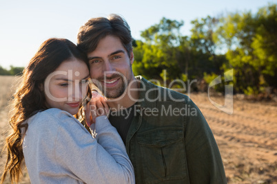 Portrait of man with woman on field