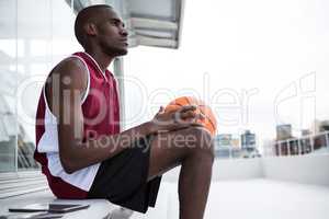 Thoughtful player holding basketball