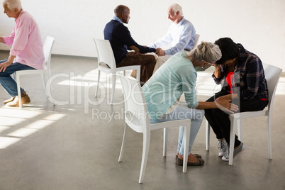 Senior people sitting face to face