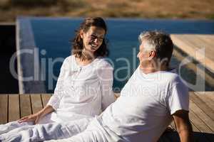 Happy couple relaxing on wooden plank