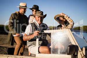 Happy friends enjoying in vehicle during safari vacation