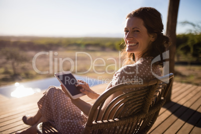 Senior woman using digital tablet while sitting