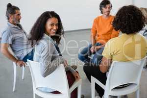 Portrait of smiling woman sitting with friends