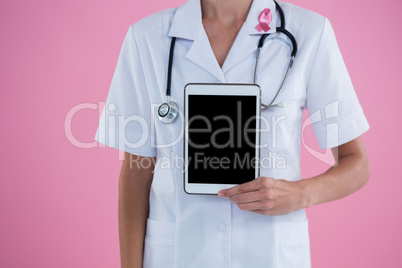 Mid section of female doctor showing tablet computer Mid section of female doctor showing tablet computer
