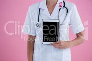 Mid section of female doctor showing tablet computer