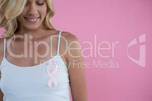 Smiling woman with Breast Cancer Awareness ribbon