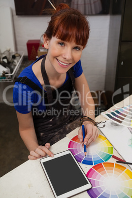 Portrait of beautiful woman matching color with color swatch