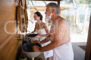 Couple looking at mirror in cottage