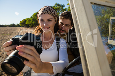 Couple looking at camera in off road vehicle