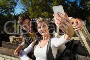 Couple taking selfie in off road vehicle