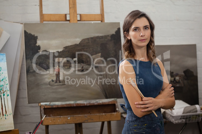 Portrait of confident woman standing with arms crossed
