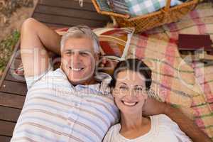 Portrait of happy couple relaxing in cottage