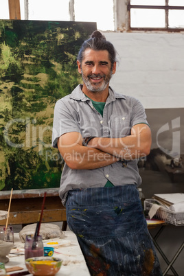 Portrait of confident man standing with arms crossed