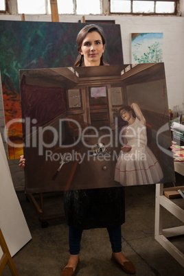 Woman holding a painting in drawing class