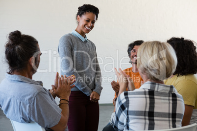 Smiling friends looking at woman