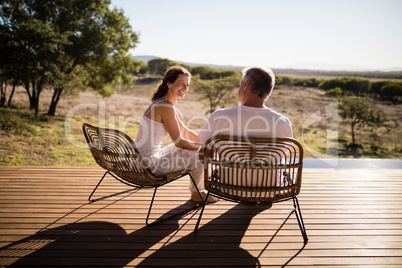 Senior couple sitting on chairs at the resort