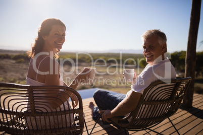 Senior couple having coffee while sitting at the resort
