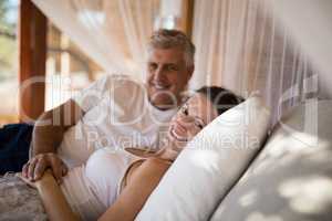 Senior couple sleeping on canopy bed