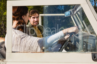 Woman with man driving off road vehicle