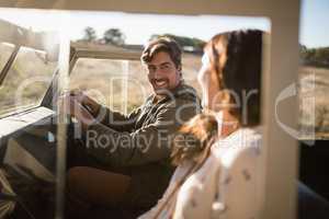 Young couple interacting while travelling in vehicle