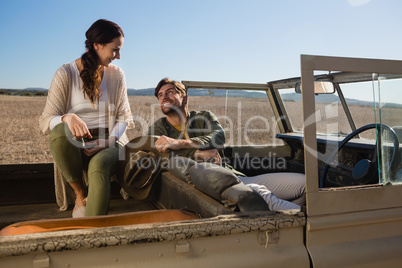 Couple relaxing in off road vehicle