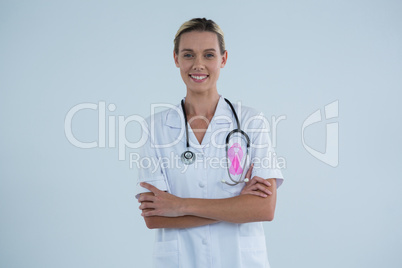 Portrait of female doctor with Breast Cancer Awareness ribbon