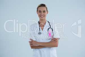 Portrait of female doctor with Breast Cancer Awareness ribbon