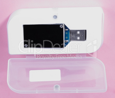 electronic device in plastic case on pink background at day