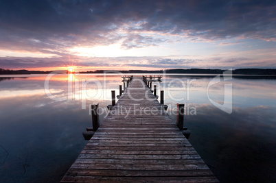 a long pier leading out onto the lake, sunrise on lake, long way out