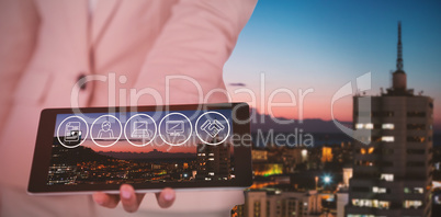 Composite image of midsection of businesswoman holding digital tablet