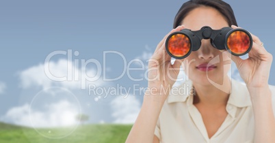 Businesswoman in nature field with binoculars