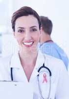 Doctor woman with breast cancer awareness ribbon