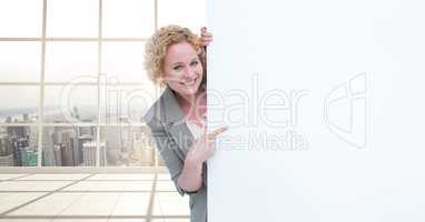Happy business woman holding blank card in office