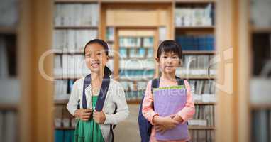 Two school children in library