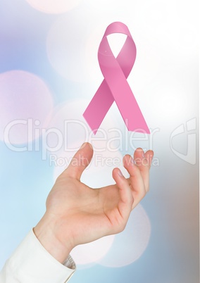 Open hand with pink ribbon for breast cancer awareness