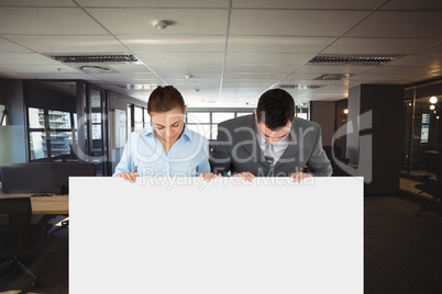 Business people holding blank card in office