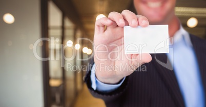 Business man holding blank card in office