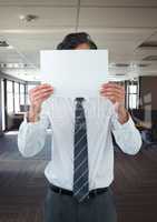 Business man holding blank card in office