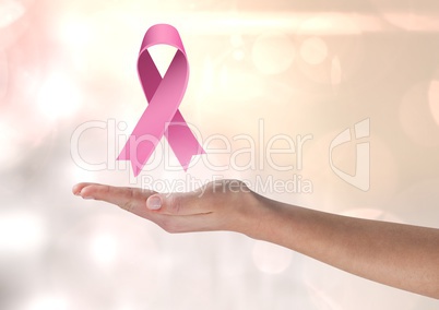 Open hand with pink ribbon for breast cancer awareness