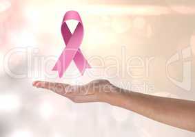 Open hand with pink ribbon for breast cancer awareness