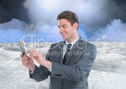 Businessman on phone in sea of documents under sky clouds