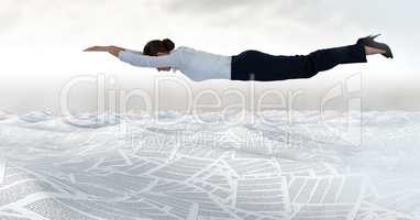 Businesswoman flying in sea of documents under sky