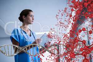 Worried doctor woman sitting with 3D DNA strand and cells