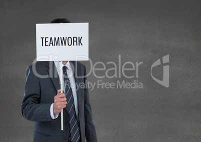 Business man holding a card with teamwork text