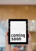 Business woman holding a tablet with coming soon text