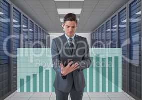 Business man holding a tablet and graphics in server room